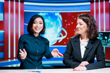 Morning show hosts debate events, presenting latest news on international television network in...