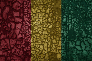 flag of guinea on a old grunge metal rusty cracked wall background