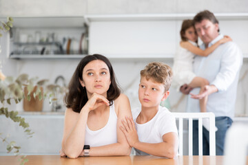 Upset family with son and daughter arguing in kitchen at home