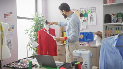A mature bearded man tailoring a red shirt in a brightly lit atelier, surrounded by fashion design...