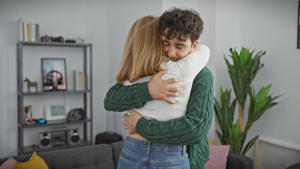 Couple embracing lovingly in a cozy living room, conveying a sense of love, togetherness, and...