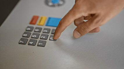 Close-up of a finger pressing a button on a pos terminal keypad during a transaction.