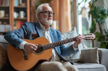 An older man sitting on the couch playing an acoustic guitar