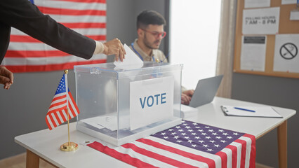 A man votes in a usa election at an indoor polling station with american flags.