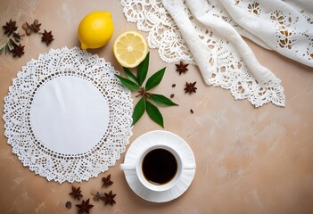 Whole and sliced lemons with green leaves, star anise, and a cup of coffee on a lace doily against a light background