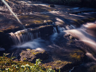 Stunning nature scene at Fowley's fall. Waterfall with blurred water. Nature background. Travel and...