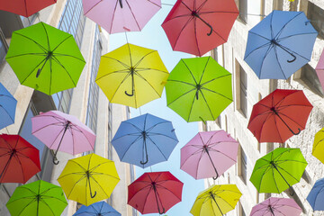 street in Jerusalem, Israel, adorned with multi-colored umbrellas, creating a fest picturesque scene for pedestrians.