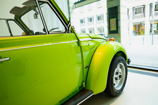 classic green vintage car Volkswagen VW Beetle Cabriolet, automotive nostalgia, display Iconic show Volkswagen Group Forum in Berlin, Germany - April 24, 2024