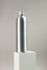 Metallic silver bottle with screw cap without label. Medicine and cosmetics