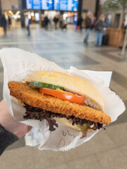 Fresh Tasty Chicken Sandwich in a Busy Train Station