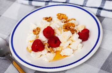 Healthy breakfast, light and hearty dietary snack - cottage cheese with honey, walnut and some...