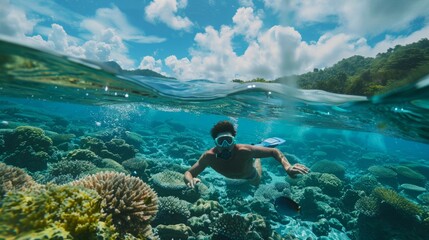 A man swimming in the ocean near a vibrant coral reef. The crystal-clear water allows for a close-up view of the diverse marine life below.