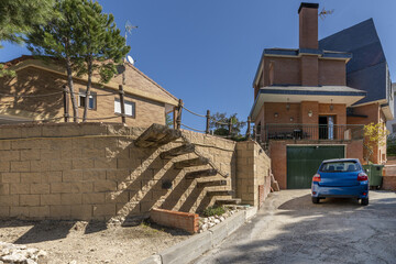 Estate with gardens and wooden steps made with train sleepers integrated into a wall in an...