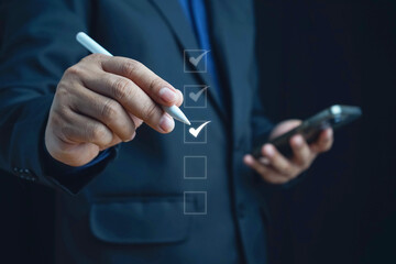 Business performance checklist, businessman using laptop doing online checklist survey, filling out...