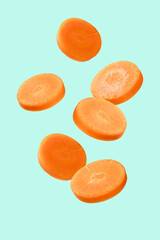  Fresh carrot slices levitation on cyan background