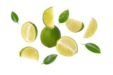 Flying lime with half , slices and leaves isolated on white background.