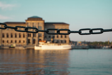 close-up of a chain with a city in the background