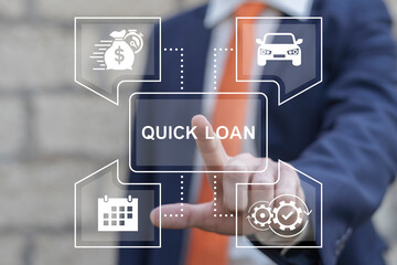 Business man working on virtual touch screen presses inscription: QUICK LOAN. Concept of quick and...