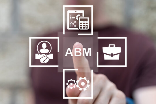 Man working on virtual touch screen presses abbreviation: ABM. ABM Account Based Marketing Concept. Business Web Marketing Technology.