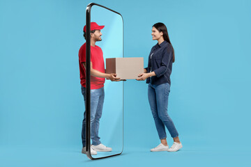 Courier delivering parcel to woman through huge smartphone on light blue background