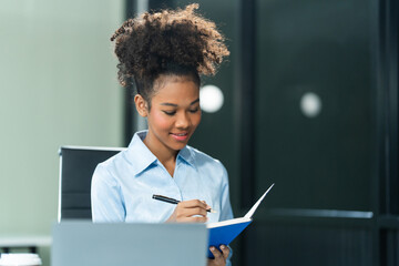Young female African American in a blue formal shirt with afro brown hair works as a Market...