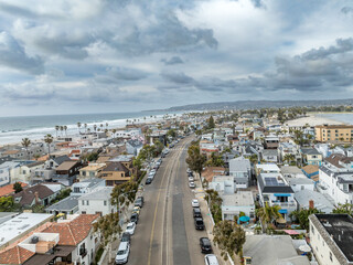 Aerial view of beach house properties for rental on Mission Beach San Diego California with cloudy sky