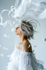 A woman in a white dress with her hair blowing in the wind