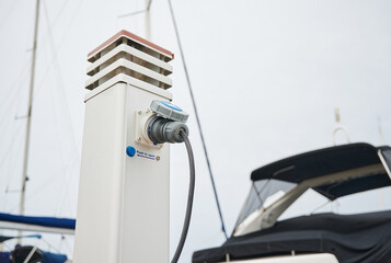 Socket and shore power pedestal for plugging in and loading electricity for sailboats and yachts at...