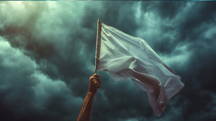 hand rise with white flag for surrender or peace sign against dramatic storm clouds in the sunset sky.