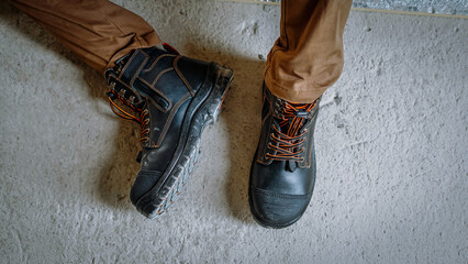 A construction worker wears brown leather boots which looks very cool and fashionable