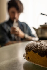chocolate cake and in the background a person drinking mate (Argentine tradition)