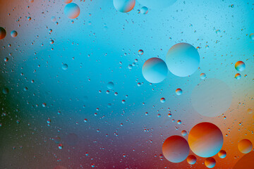 Macro oil and water multi colored abstract background.  holiday postcard background. oil drops on...