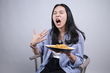 Young Asian Woman Opening Mouth Showing Spicy While Eating Noodles Isolated On White Background