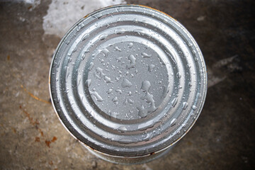 Close up of Canned food in a tin can with water drops