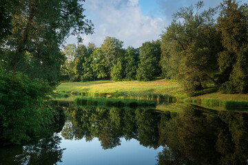 Obraz premium Slavyanka River Valley in the landscape part of the Pavlovsk Palace and Park Complex on a sunny summer day, Pavlovsk, Saint Petersburg, Russia