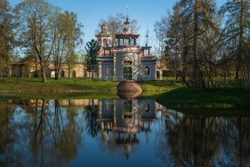 Translation of the inscription on the door "Welcome". Chinese gazebo on the bank of the Upper Ponds in the Catherine Park in Tsarskoye Selo on a sunny spring day, Pushkin, St. Petersburg, Russia