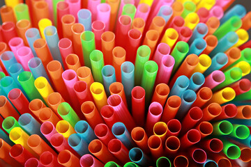 Colorful plastic straws for drinking water in the background 