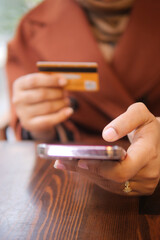  women hand holding credit card and using smart phone shopping online 