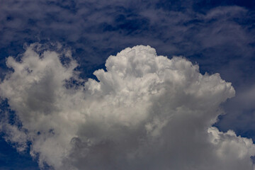big white and dark clouds in a blue sky