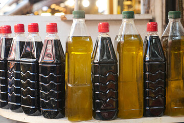 Several bottles of oil arranged on a table for food storage