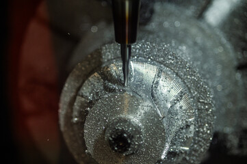 Close-up of industrial lathe, milling machine, precision work. 