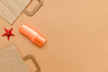 Craft bags and an orange plastic container with a red starfish on a beige background.