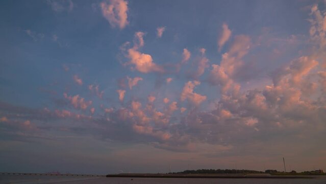 Time lapse of the Wadden Sea sunset sky at Hooksiel, North Germany with scenic red clouds moving.