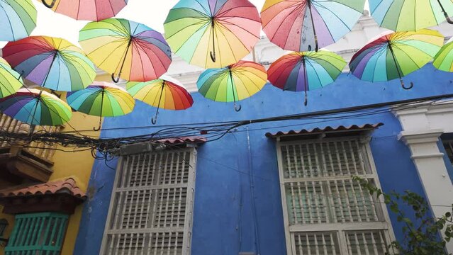 Tropical street art with colorful umbrellas, historic neighborhood Getsemani, Cartagena, Colombia