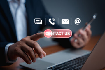 Businessman using a laptop and touch on virtual screen contact icons(live chat, phone, email, address). Contact us or the Customer support hotline people connect