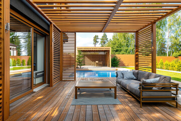 Naklejka premium Modern wooden terrace with outdoor furniture and swimming pool in the garden of a modern house