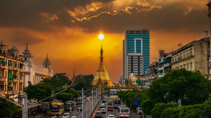 Streets of downtown Yangon Myanmar road to Sule Gold Pagoda sunset with traffic jam and modern city...