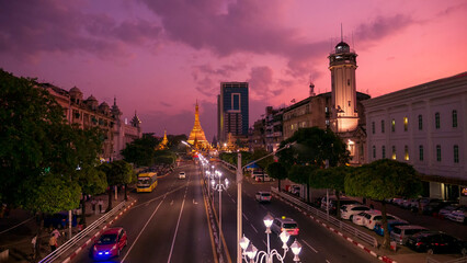 Streets of downtown Yangon Myanmar road to Sule Gold Pagoda sunset with traffic jam and modern city...