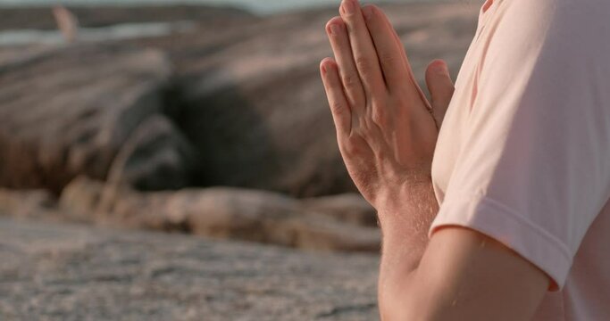 Man in yoga pose at sunset rocks at background namaste hands close-up. Namaste embracing tranquility Symbol of mental health Namaste key to serenity Each gesture towards inner peace.