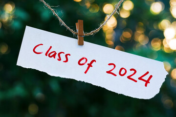 Class of 2024 writing on note paper hanging from a rope